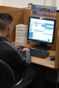 Photo of a man using a computer.